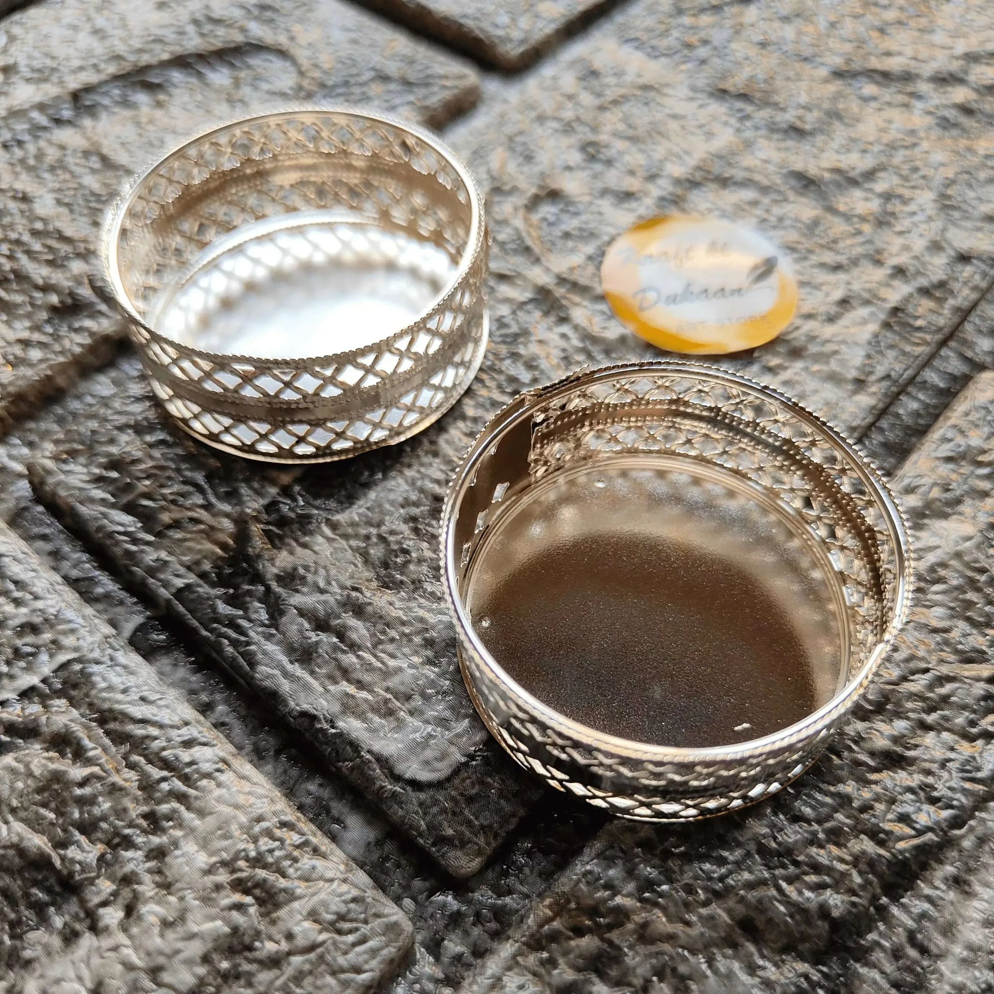 Round silver t-light holder with lattice sides and glass cup