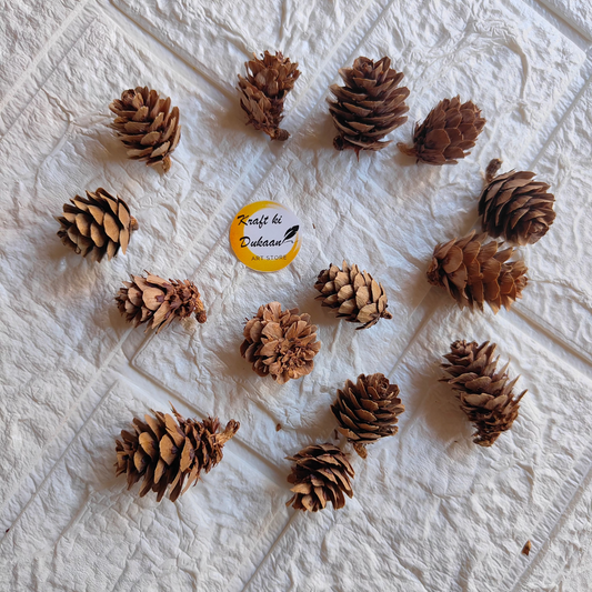 Crafted wooden flower decor featuring natural pine cones arranged artistically on a textured background