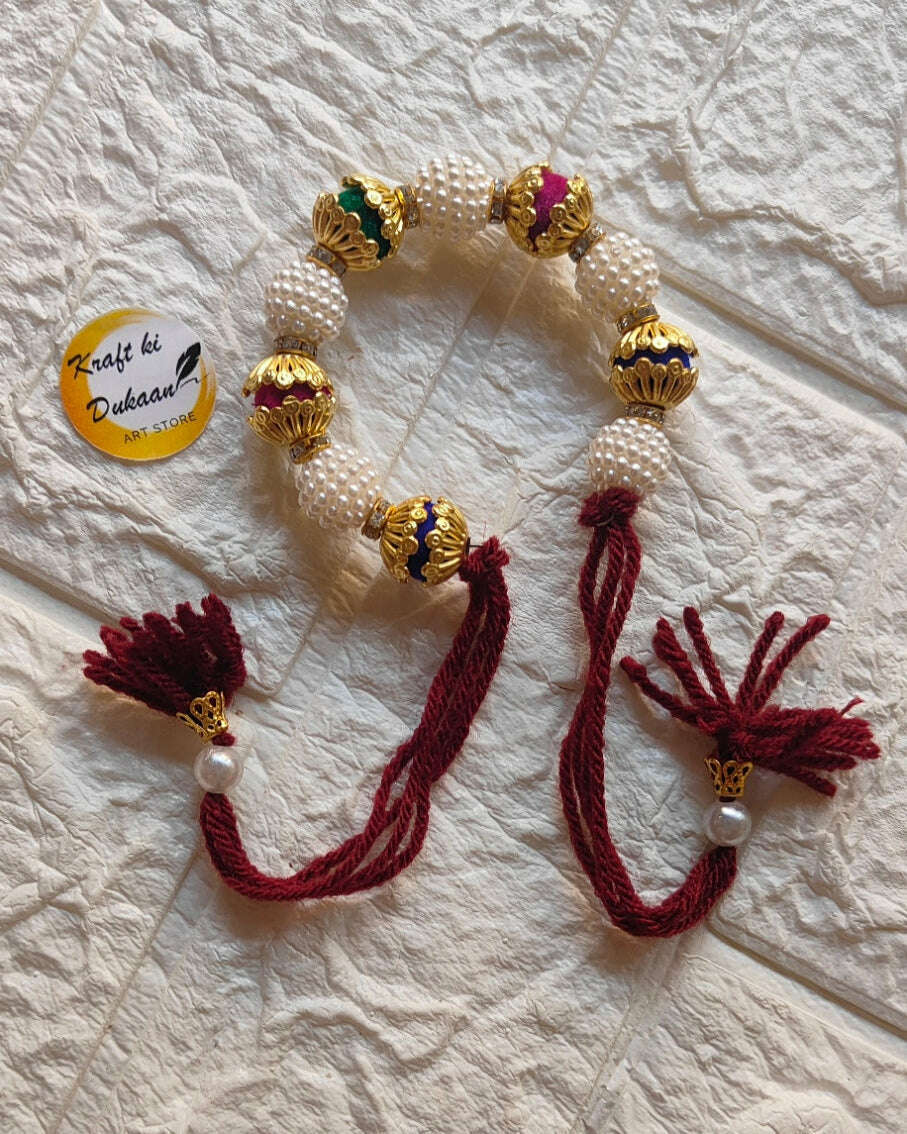 handmade-beaded-bracelet-gold-pearls-maroon-tassels