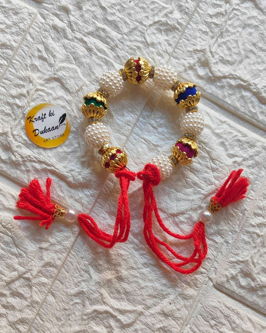 handmade-beaded-bracelet-gold-pearls-red-tassels