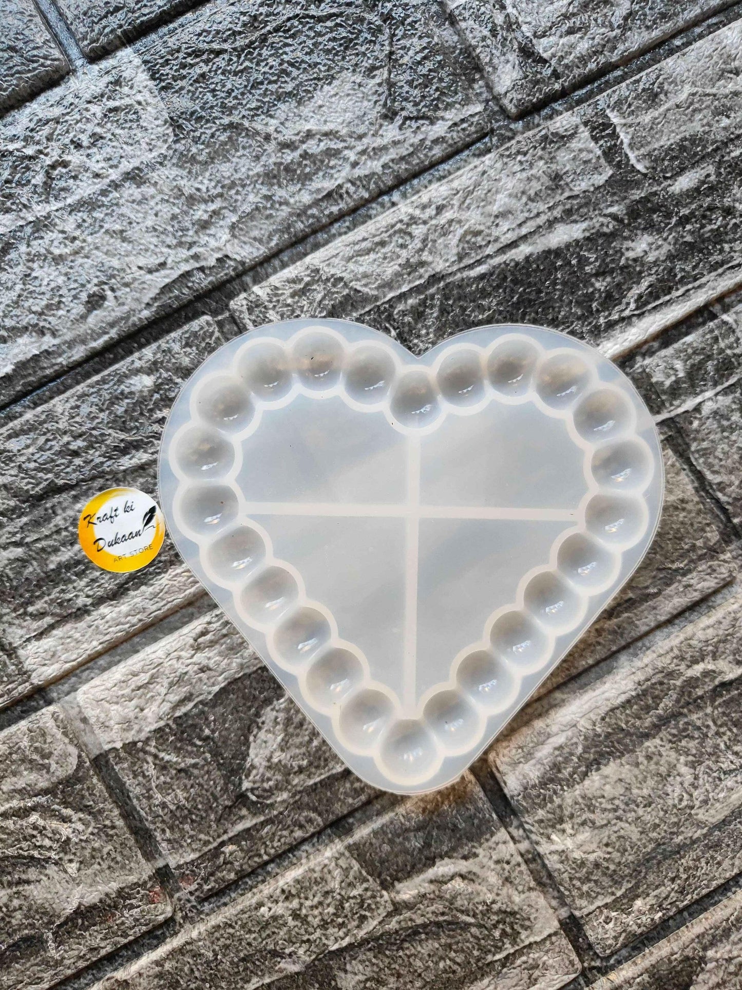 Heart bubble dish mould with cross divider and raised bubble edges, white.