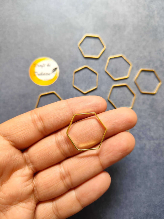 Gold-tone hexagon bezel frame held in hand, matching 10PC set.