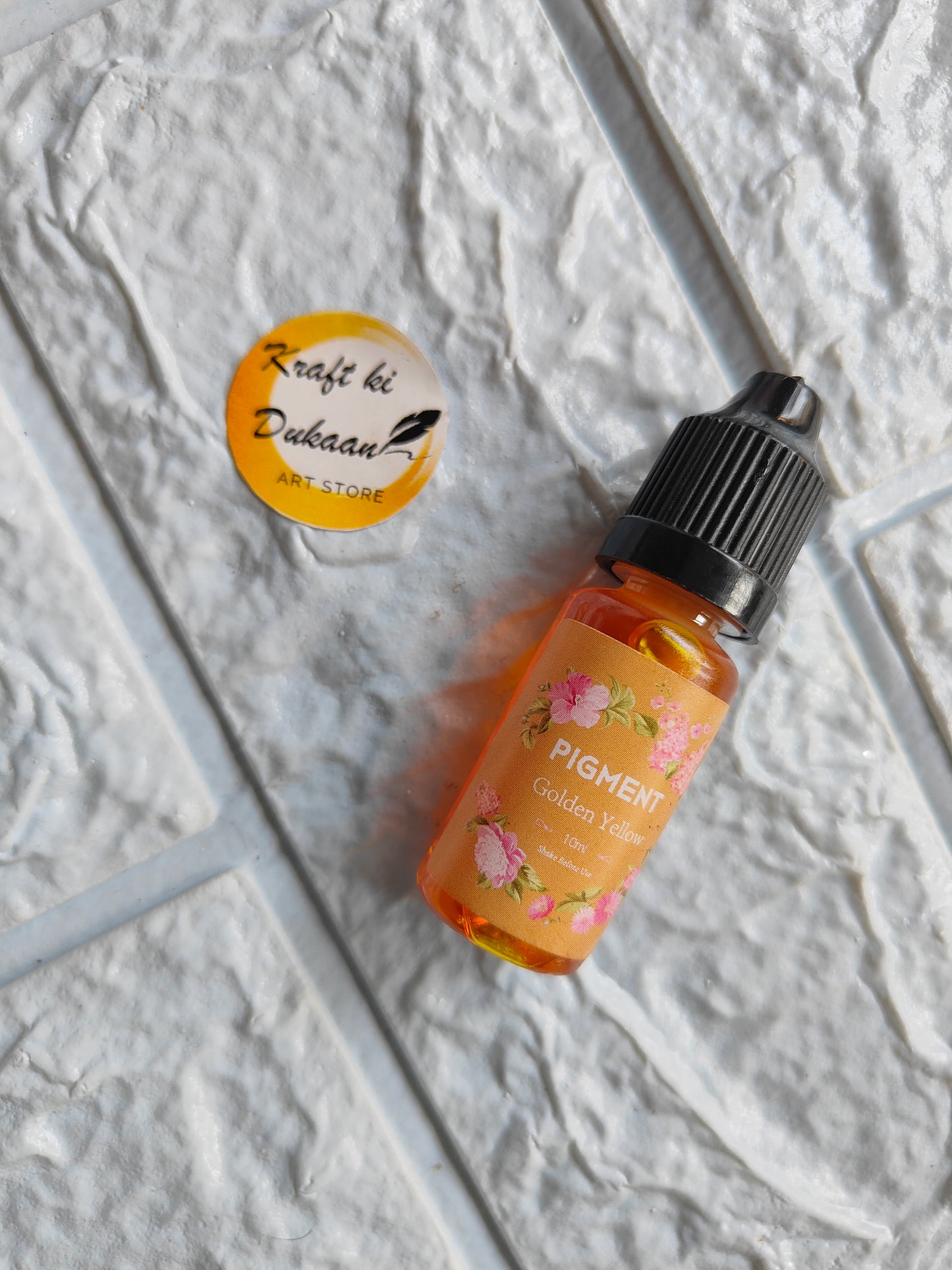 Bottle of high-quality resin pigment in Golden Yellow from Kraft ki Dukaan on textured surface
