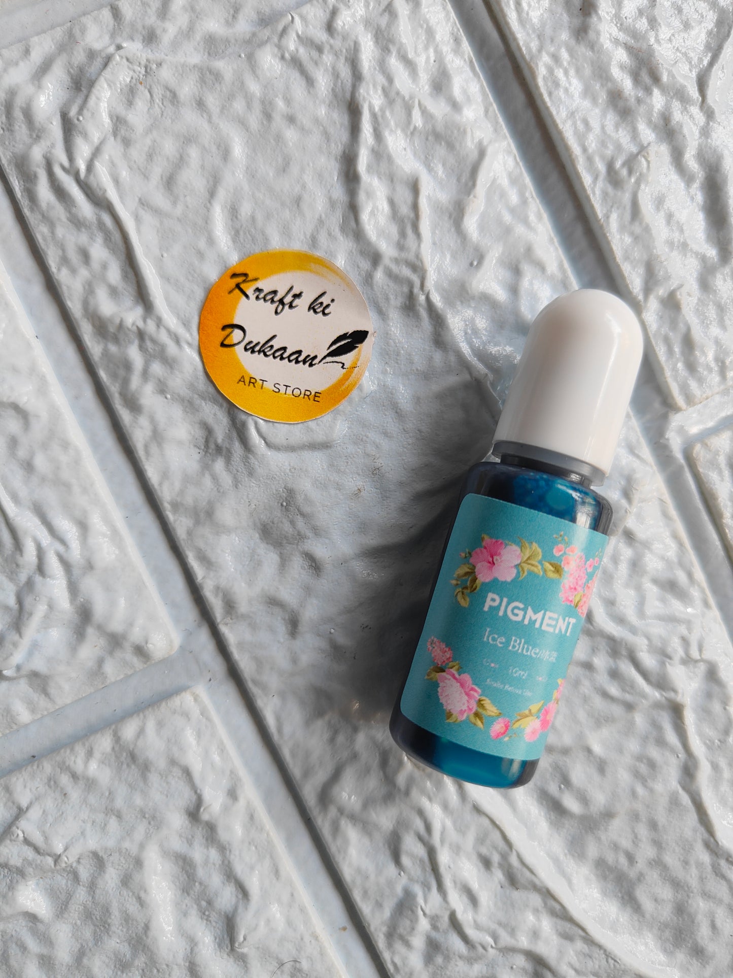 High-quality resin pigment in blue bottle with floral design for art projects