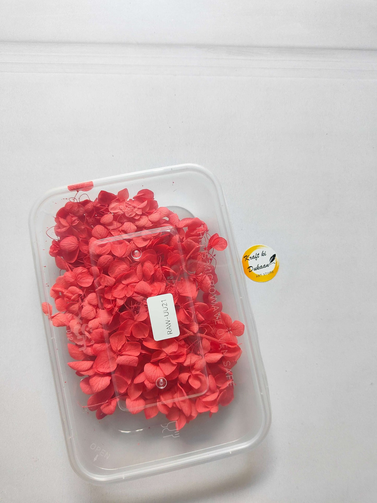 Hydrangea flower box with red hydrangea blooms in a clear plastic container