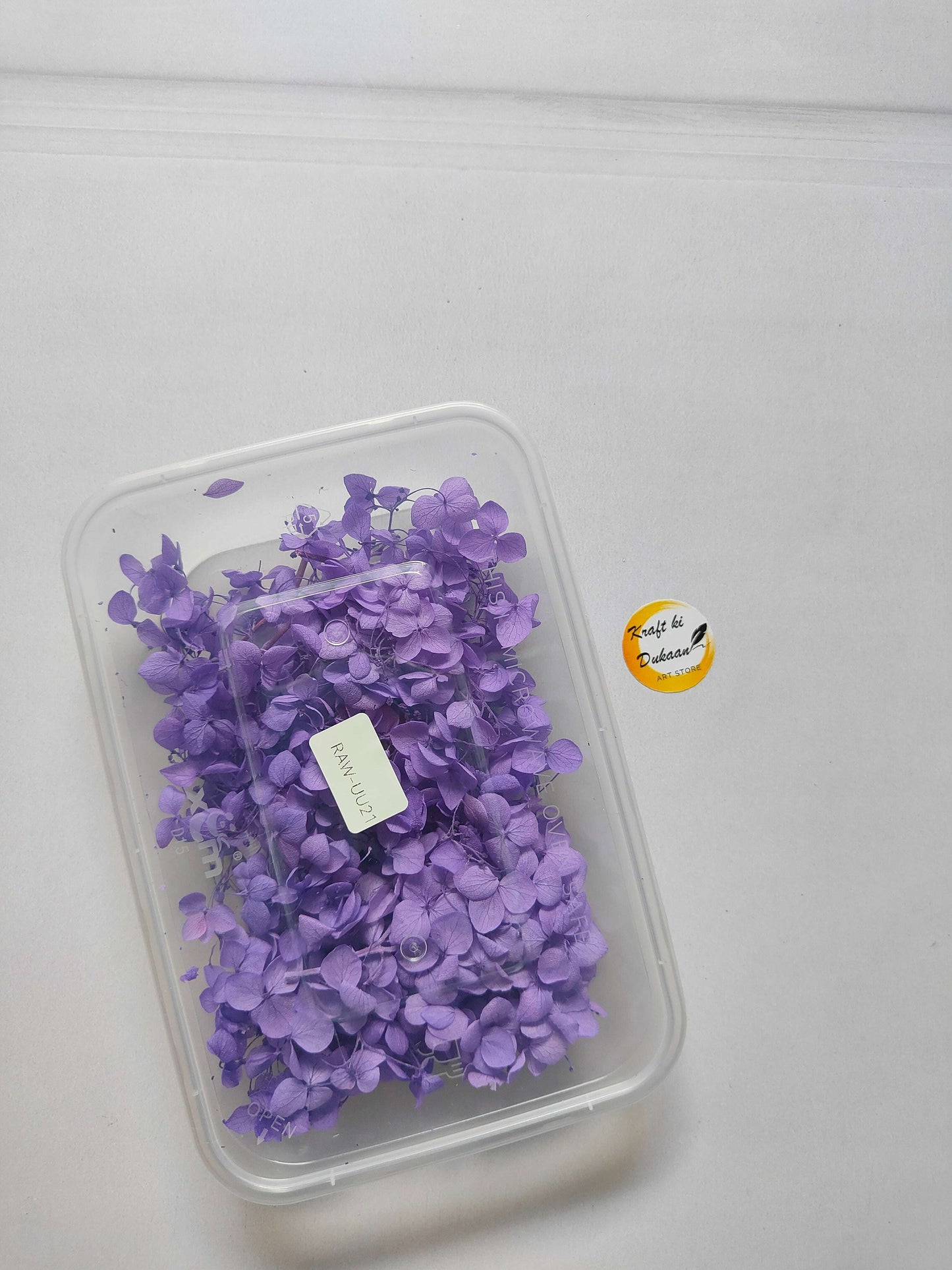 Hydrangea flower box with purple hydrangea blooms in a clear plastic container