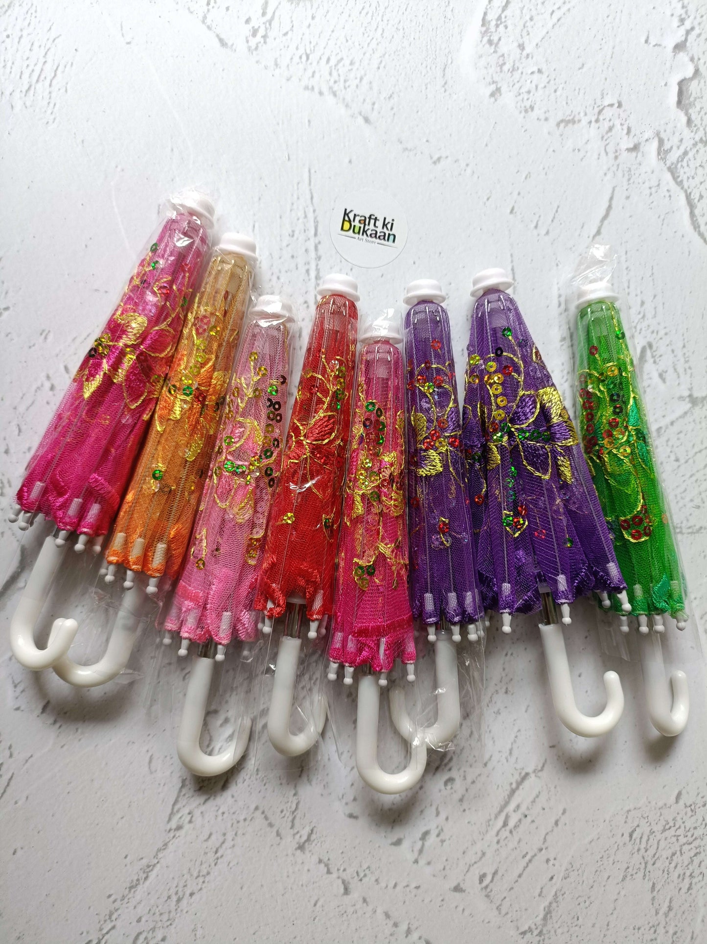 Decor umbrella set with multicolor patterned umbrellas on white hooks
