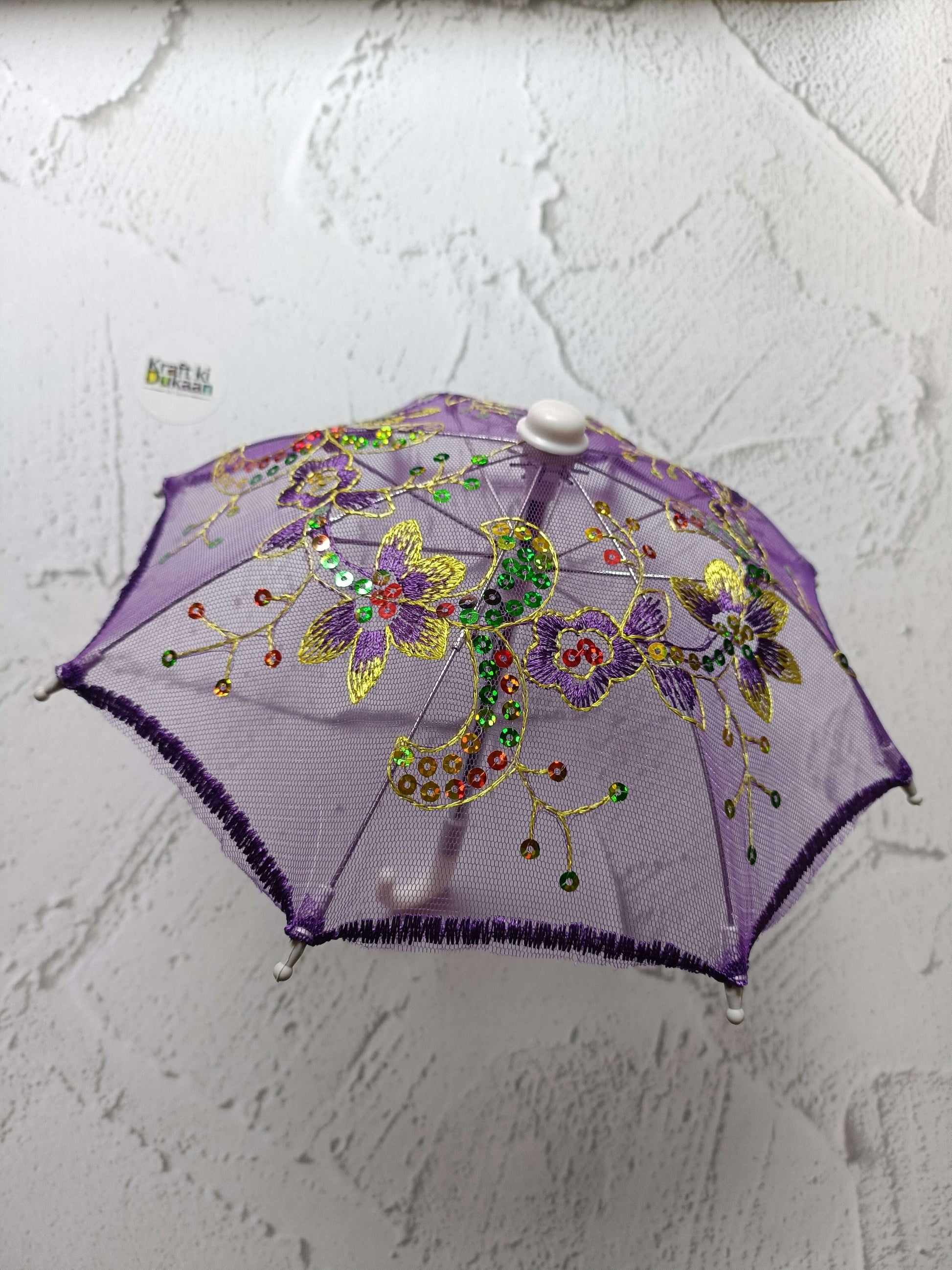 Purple decorative umbrella with floral beaded design and round top cap