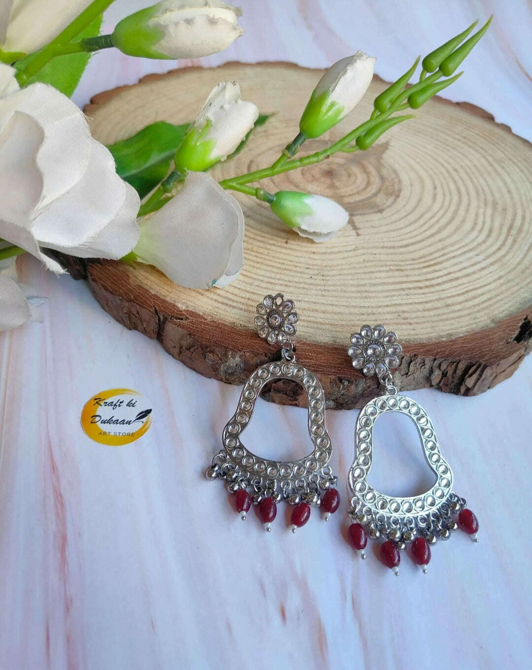 Jhumka drop earrings with silver-toned hoops and red bead fringe