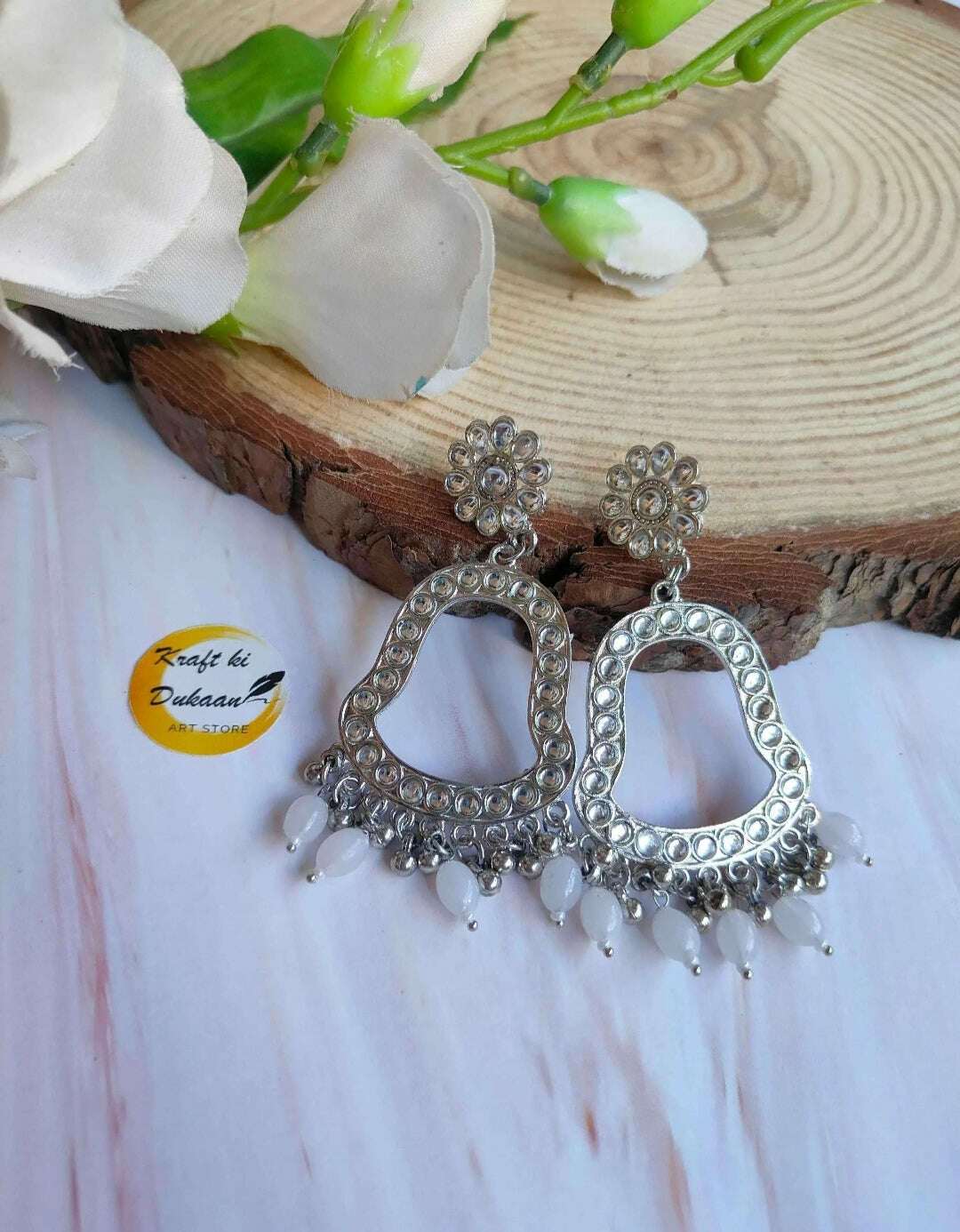Jhumka drop earrings with silver-toned hoops and white bead fringe