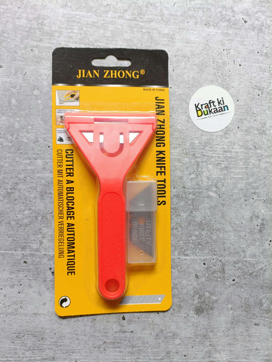 Knife tool with blades, red handle and metal scraper blade on card