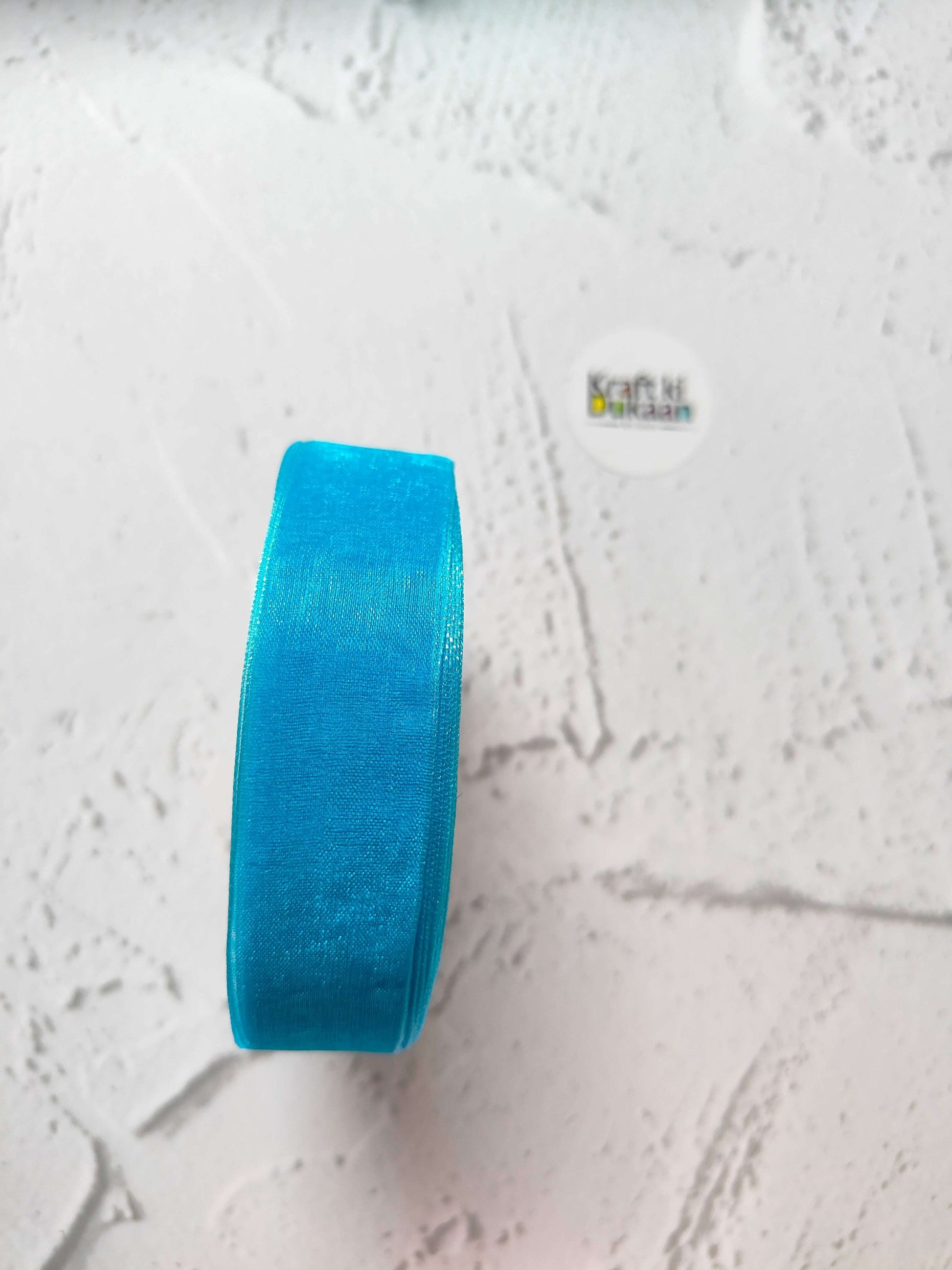 Organza ribbon roll in blue, narrow woven fabric texture