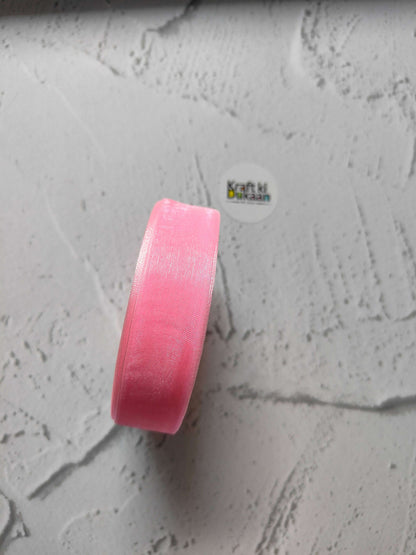 Organza ribbon roll in pink, narrow woven fabric texture