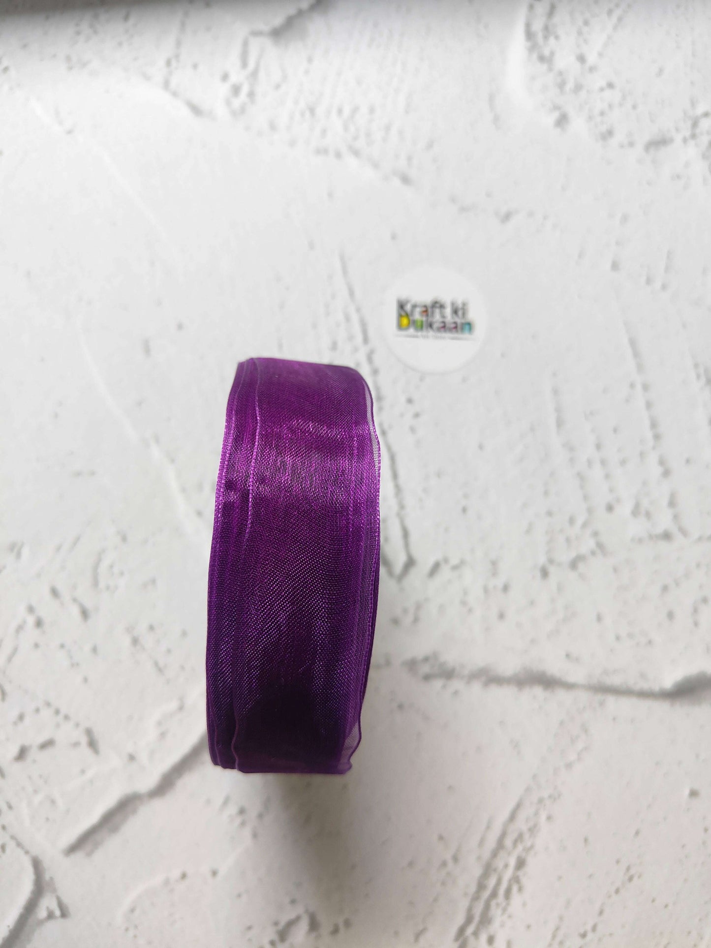 Organza ribbon roll in purple, narrow woven fabric texture