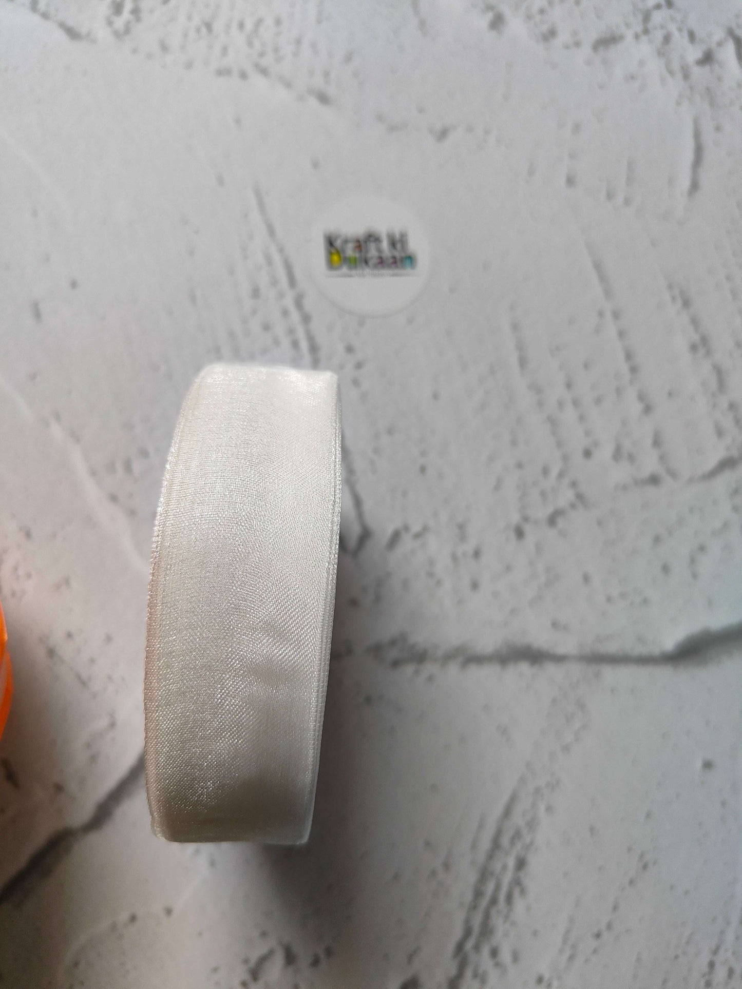 Organza ribbon roll in white, narrow woven fabric texture