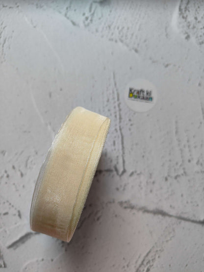 Organza ribbon roll in beige, narrow woven fabric texture