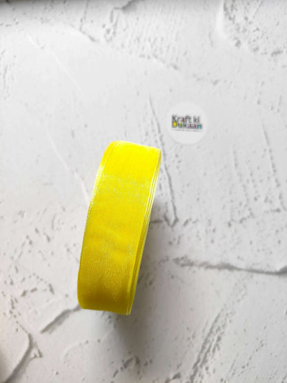 Organza ribbon roll in yellow, narrow woven fabric texture