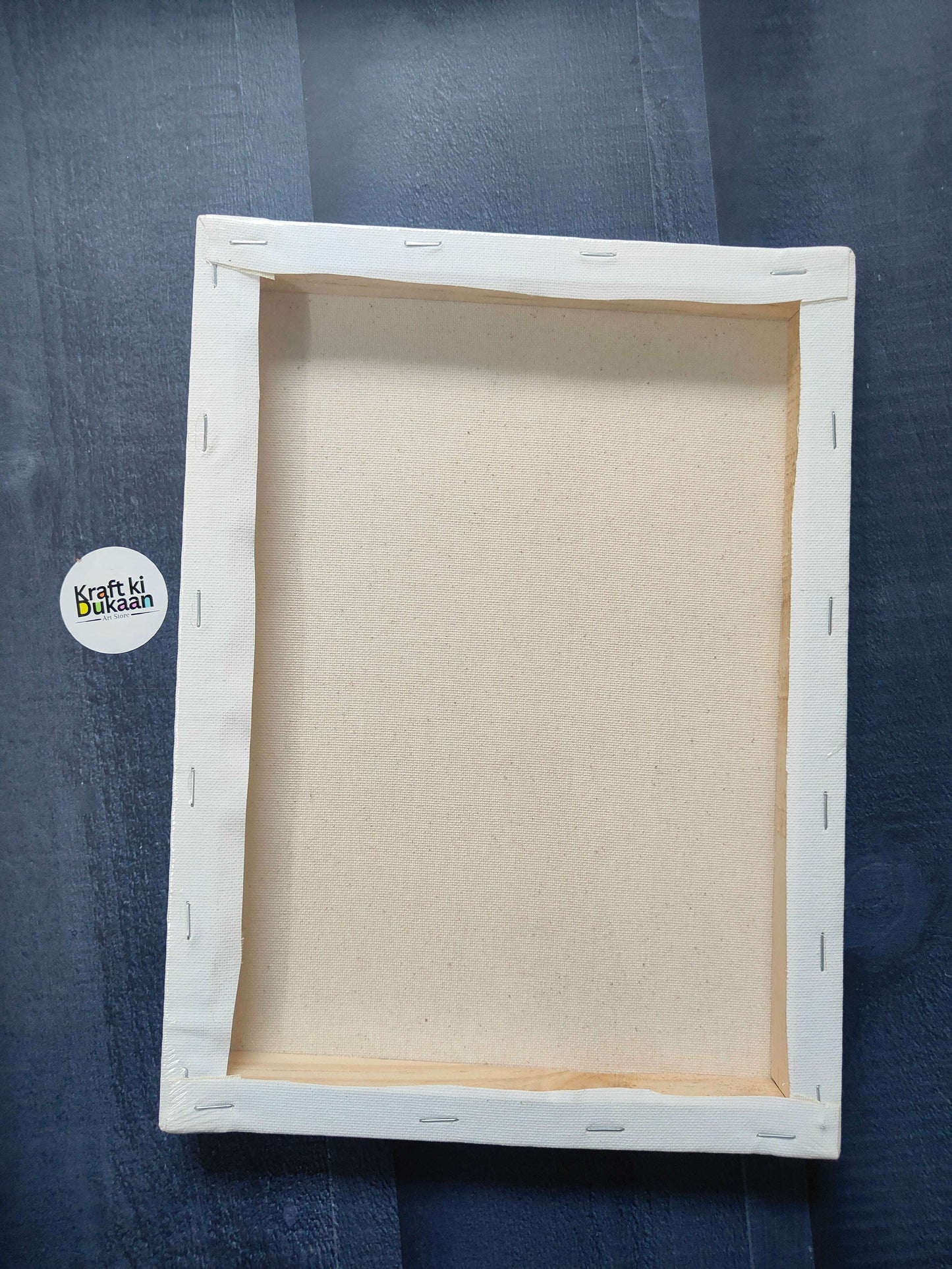 Rectangle stretched canvas board with white frame and visible beige backing, back view