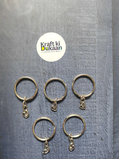 Silver round keychain rings with small chain hooks, hanging charm details