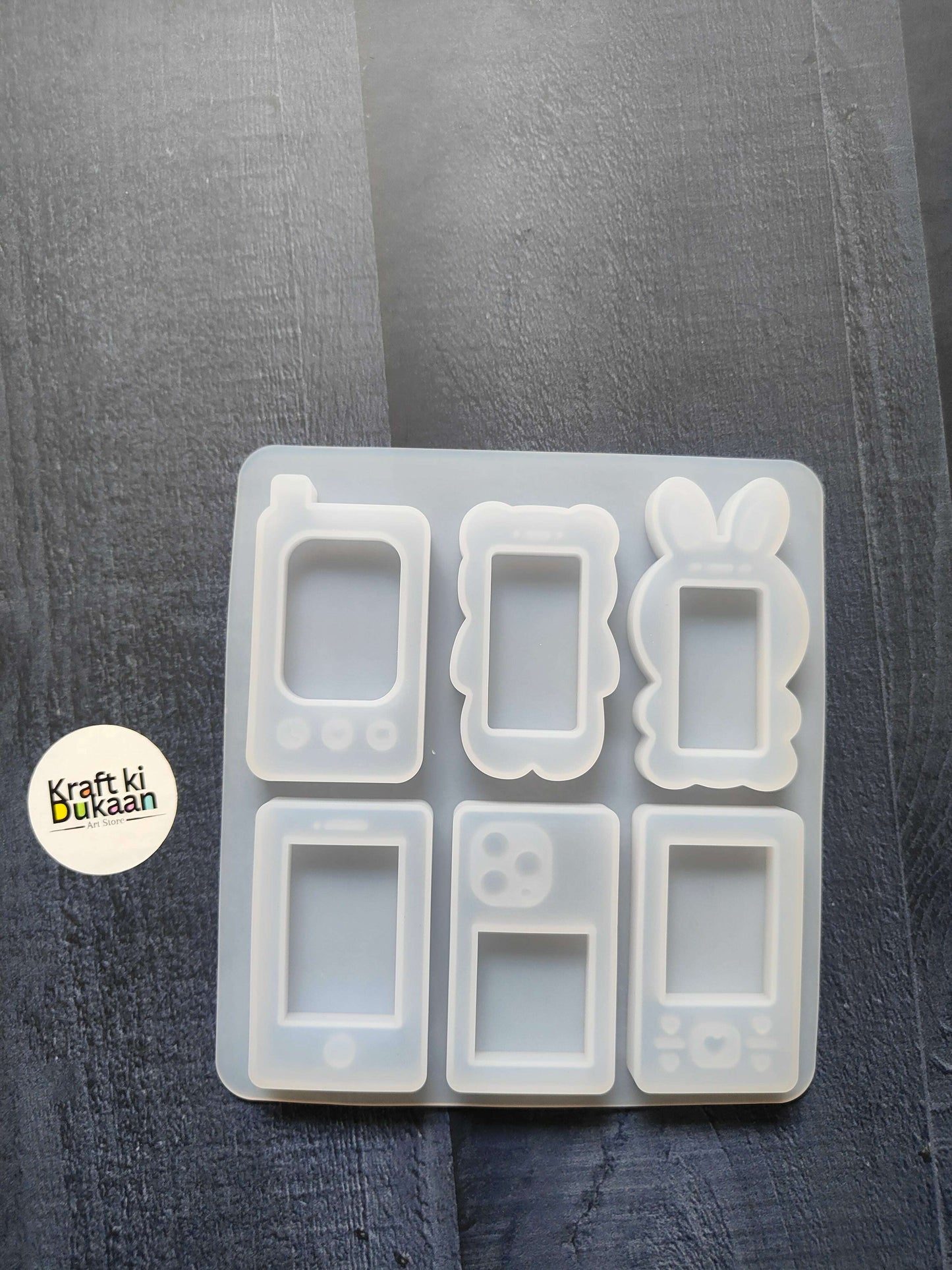 Mobile phone mould with six handset case cavity shapes in white silicone tray