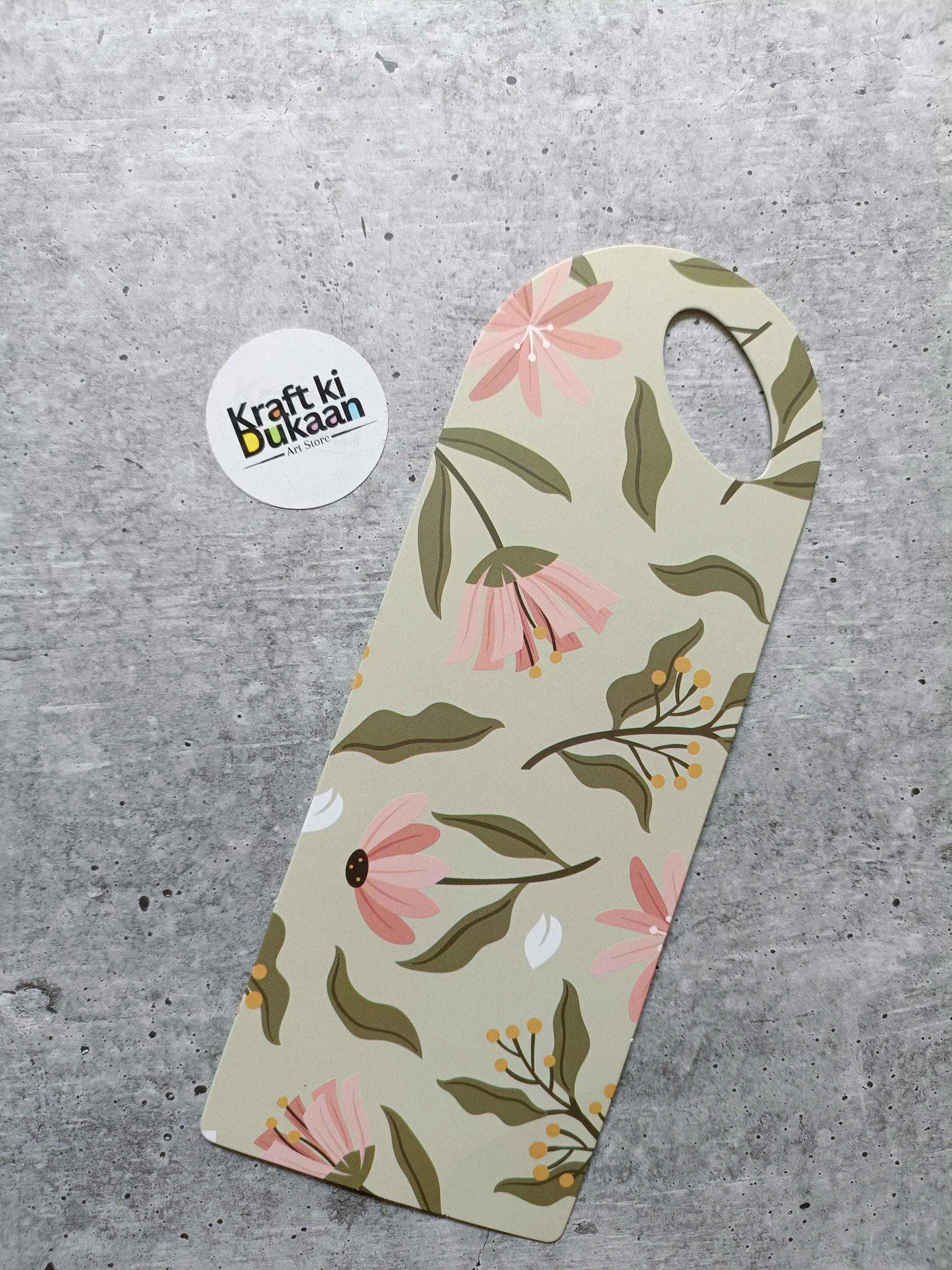 Small floral card holder, beige base with green leaves and pink flowers and handle hole
