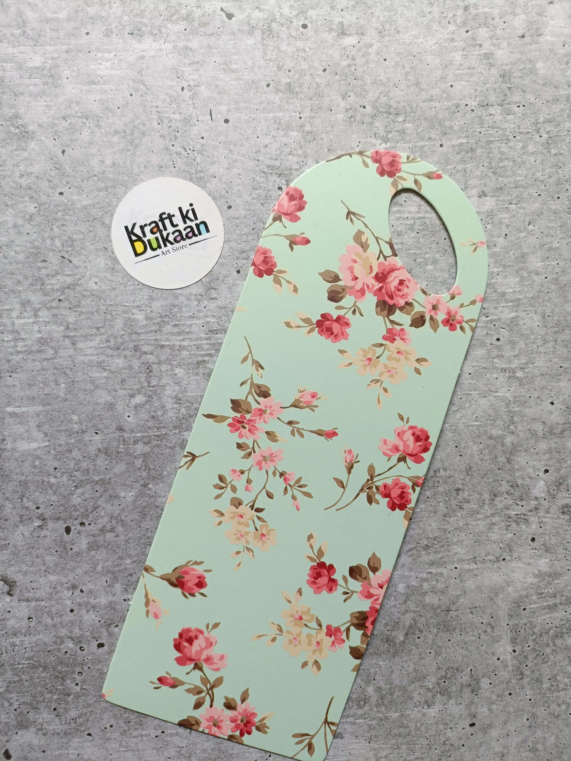 Small floral card holder, mint green with red-pink blossoms and round handle hole