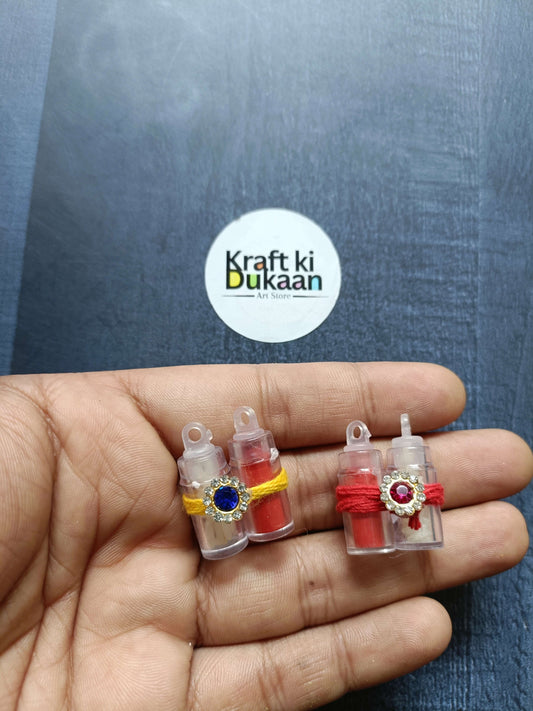 Roli chawal bottle set: 4 mini bottles with blue/red gems and yellow/red bands