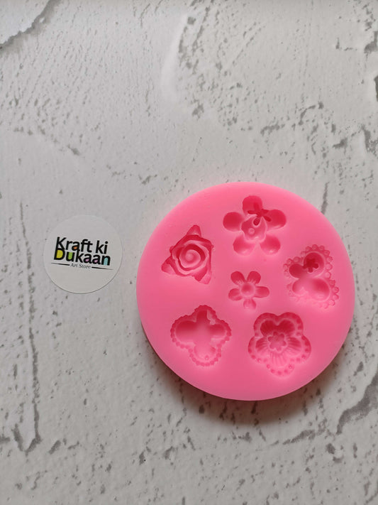 Pink 6-cavity silicone flower mold with rose, blossoms, and heart-shaped cavities