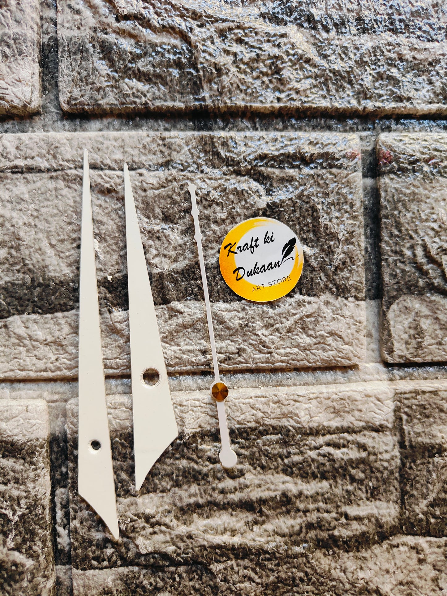 Clock hands for resin art displayed on a stone background with Kraft ki Dukaan logo