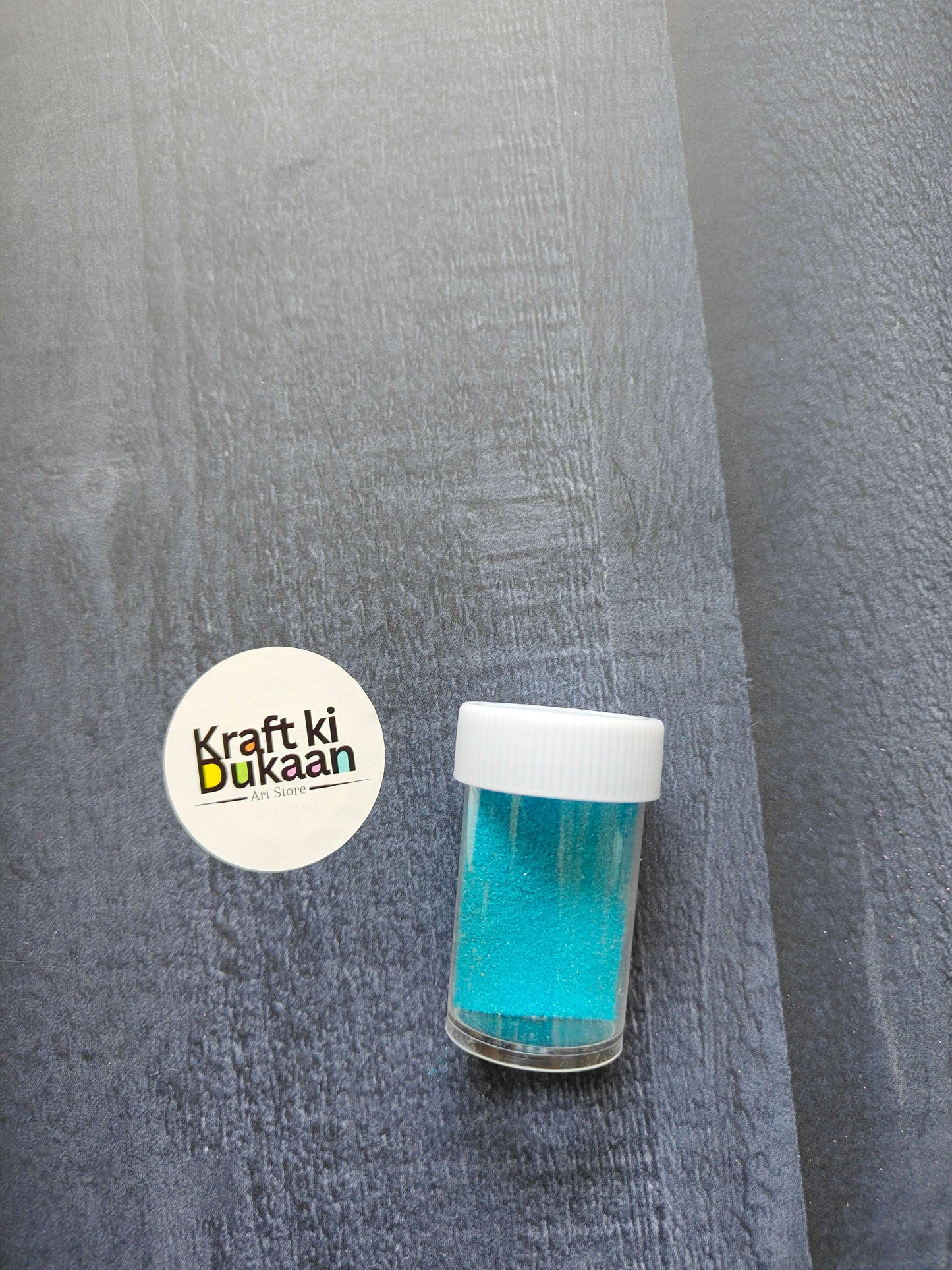 Colored Sand jar, sky blue/teal granules with white screw cap