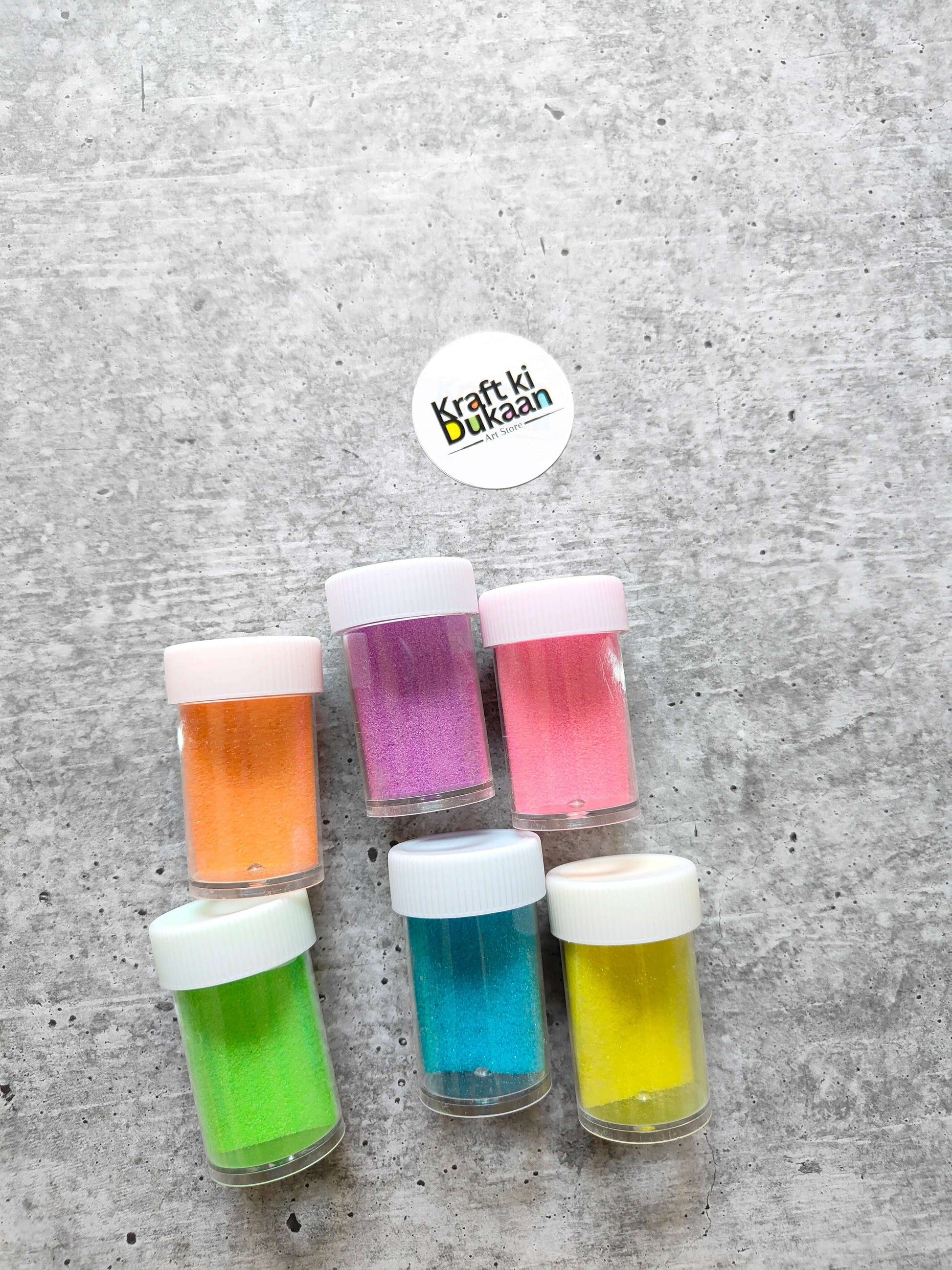 Colored Sand jars: purple, pink, orange, green, teal and yellow with white caps