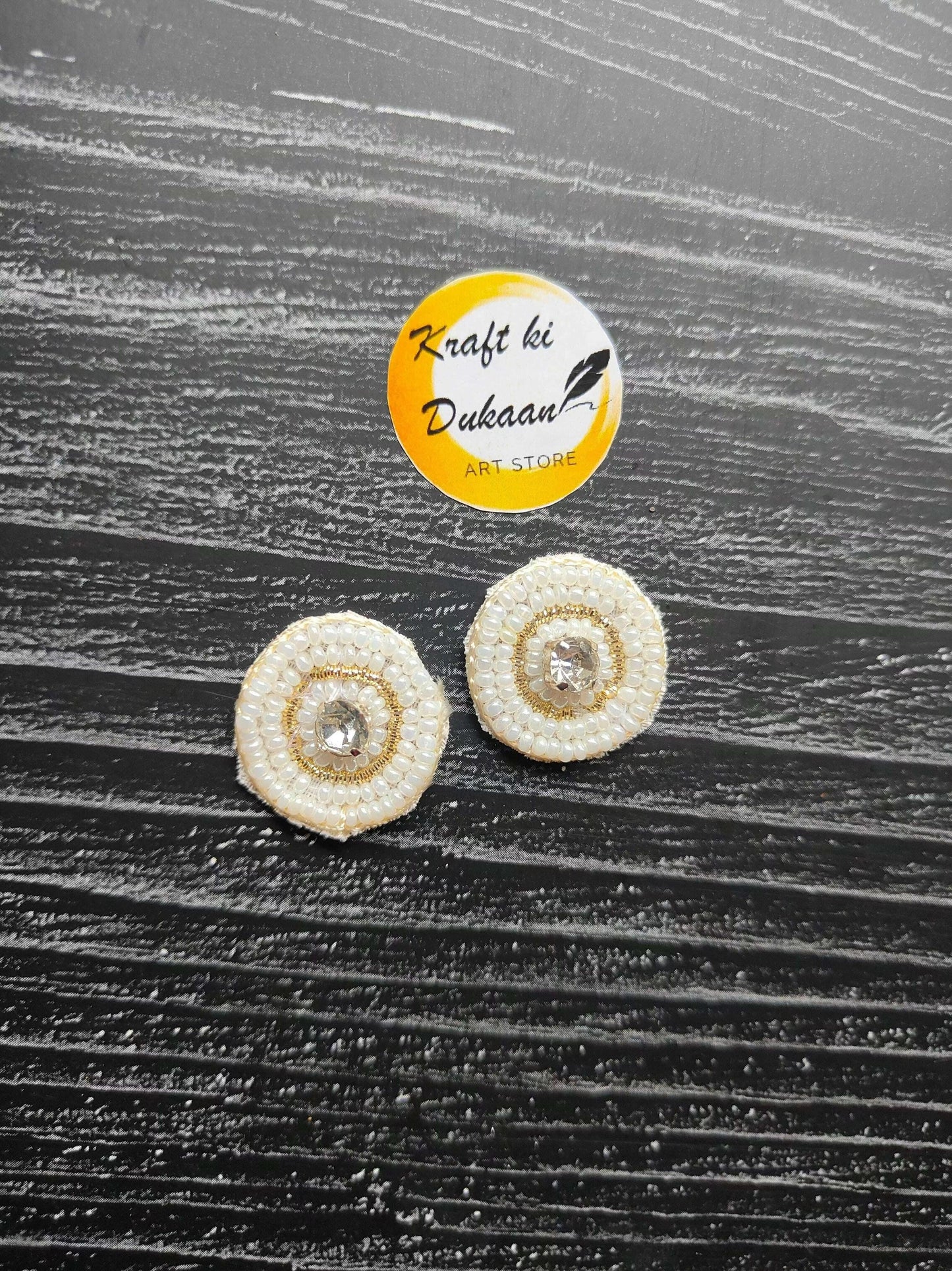 Small round beaded decorative patches, white with crystal center (2 shown)