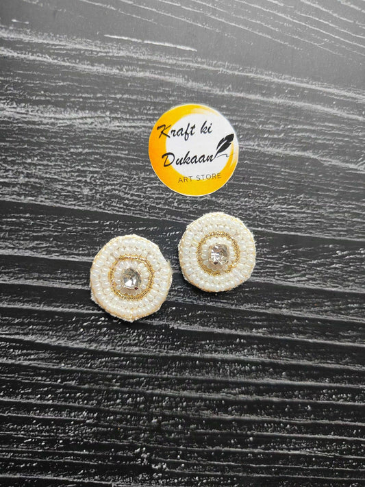 Small round beaded decorative patches, white with crystal center (2 shown)