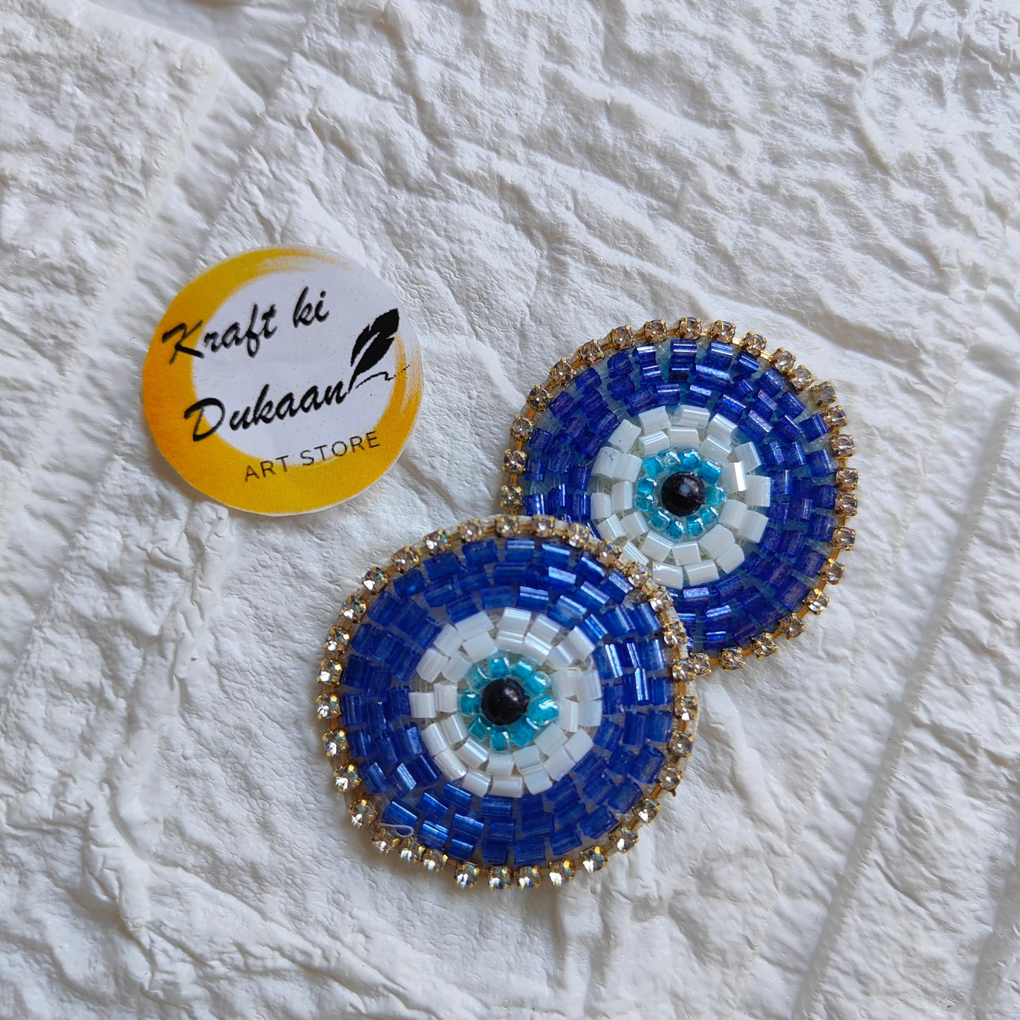 Evil eye embroidered patches in blue and white with intricate beadwork for decorative purposes