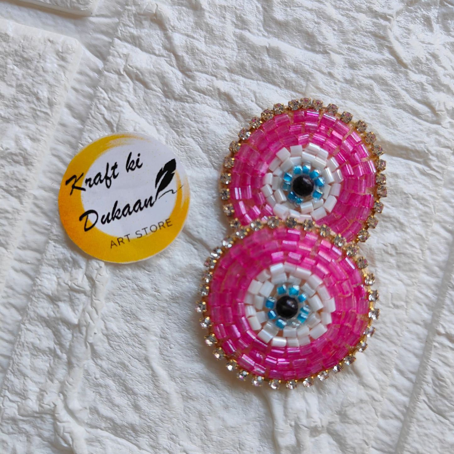 Evil eye embroidered patches in pink and white with decorative beading for crafts and embellishments