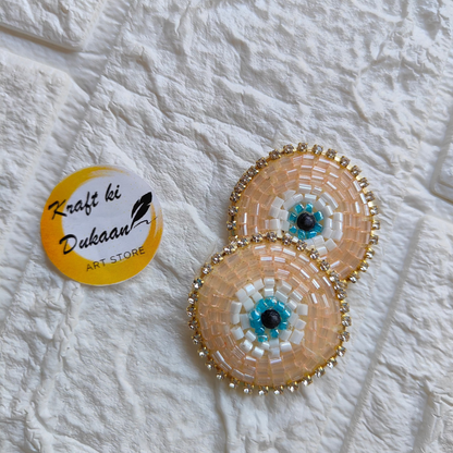 Set of two evil eye embroidered patches with colorful bead accents for decorative use