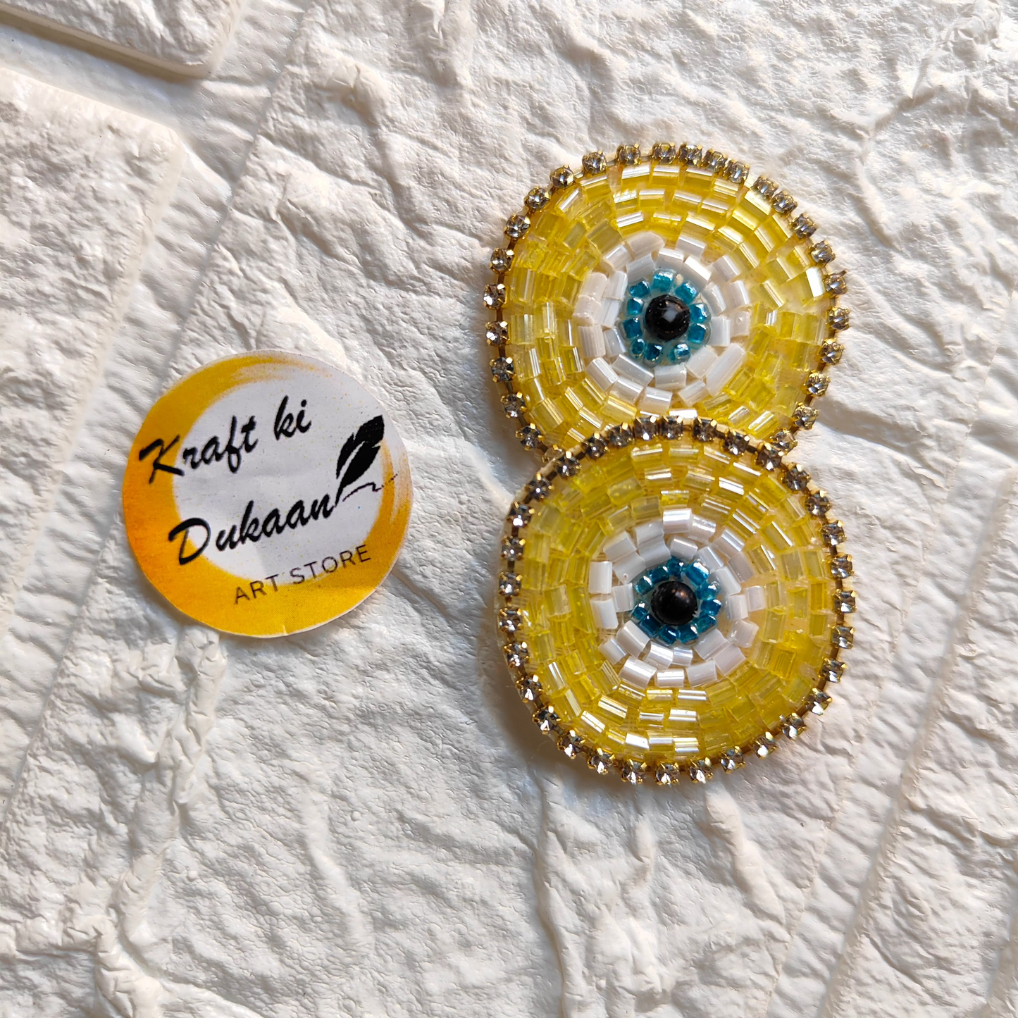Evil eye embroidered patches in yellow and white design for decorative and protective uses