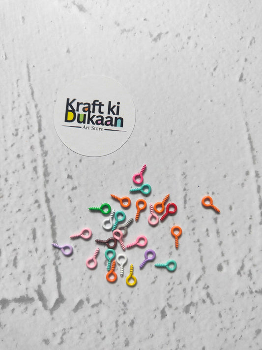 Eye screw hooks multi pack (50) scattered on surface, colorful mix