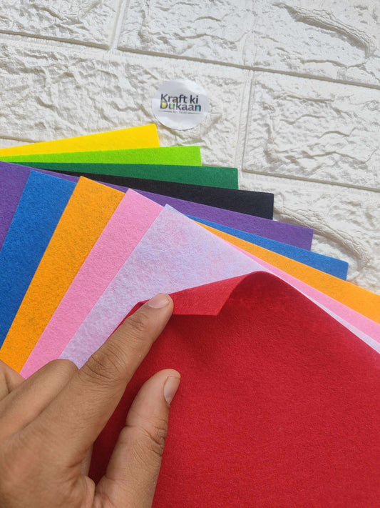 Hand holding red A4 felt sheet; multi pack of 10 with assorted colors behind