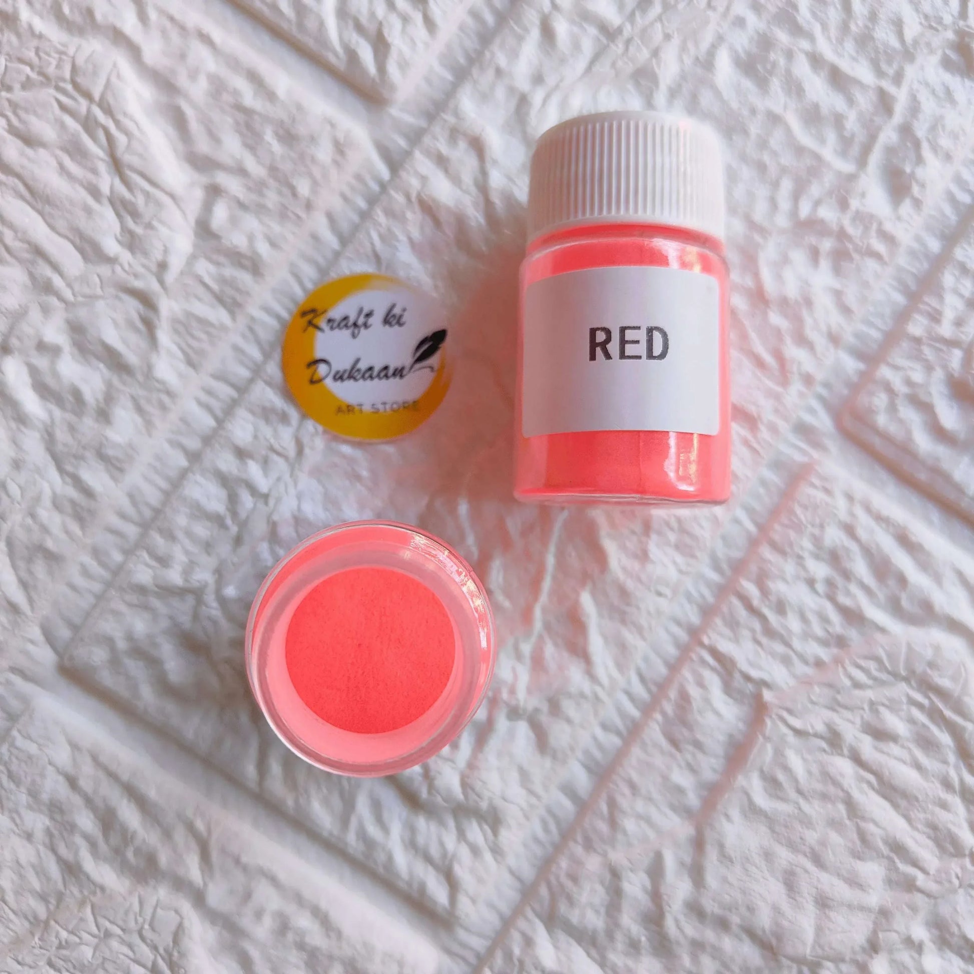 Red glow mica powder jar with red powder in open pot
