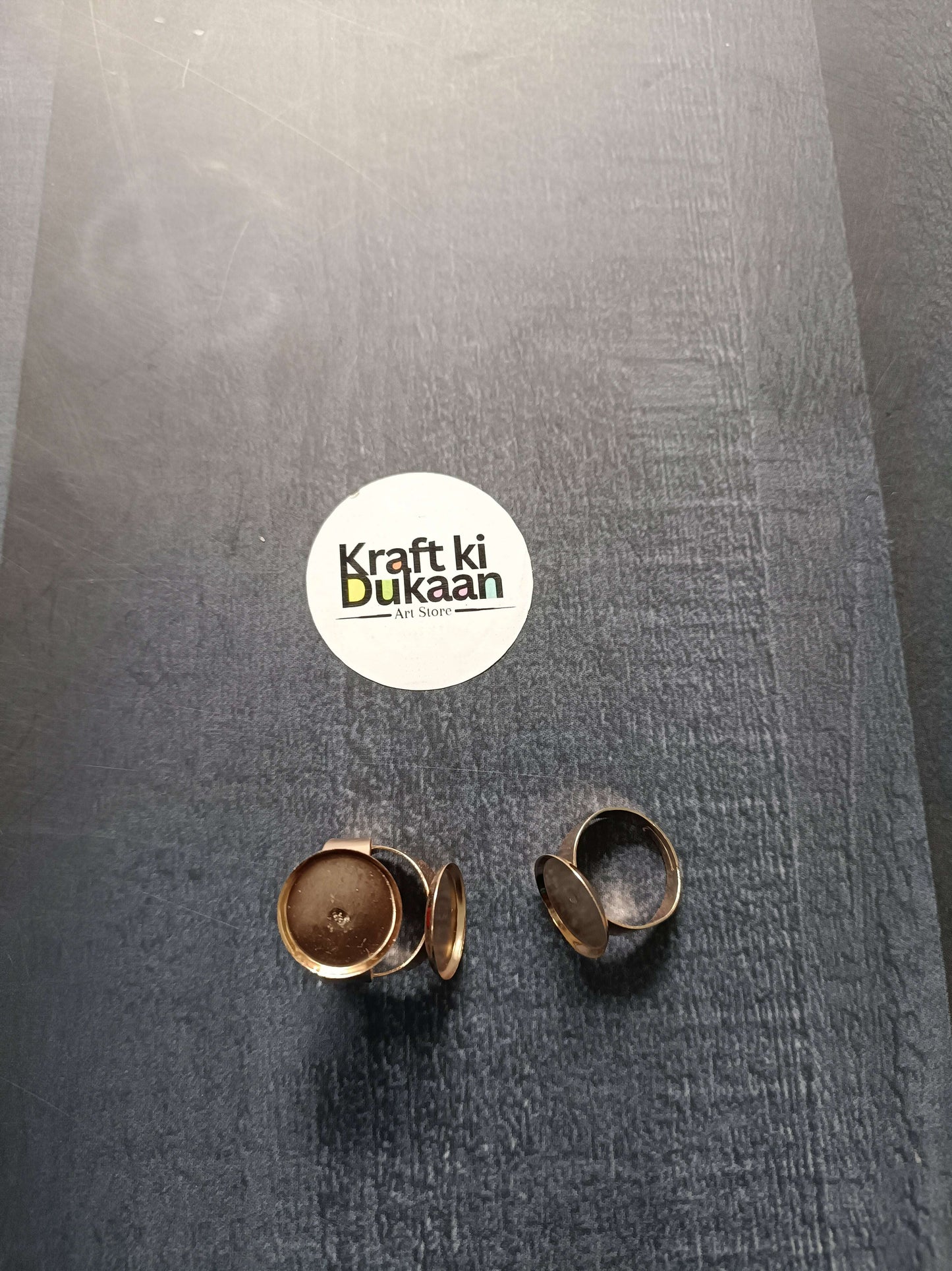 Gold-tone ring bases (2 shown), round bezels on open adjustable bands