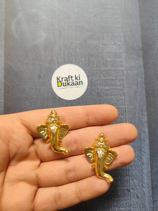 Golden Ganpati face charm, 3.5cm; two figurines held in hand