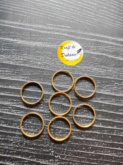 Set of golden metal rings, round hoops with open centers, grouped for view