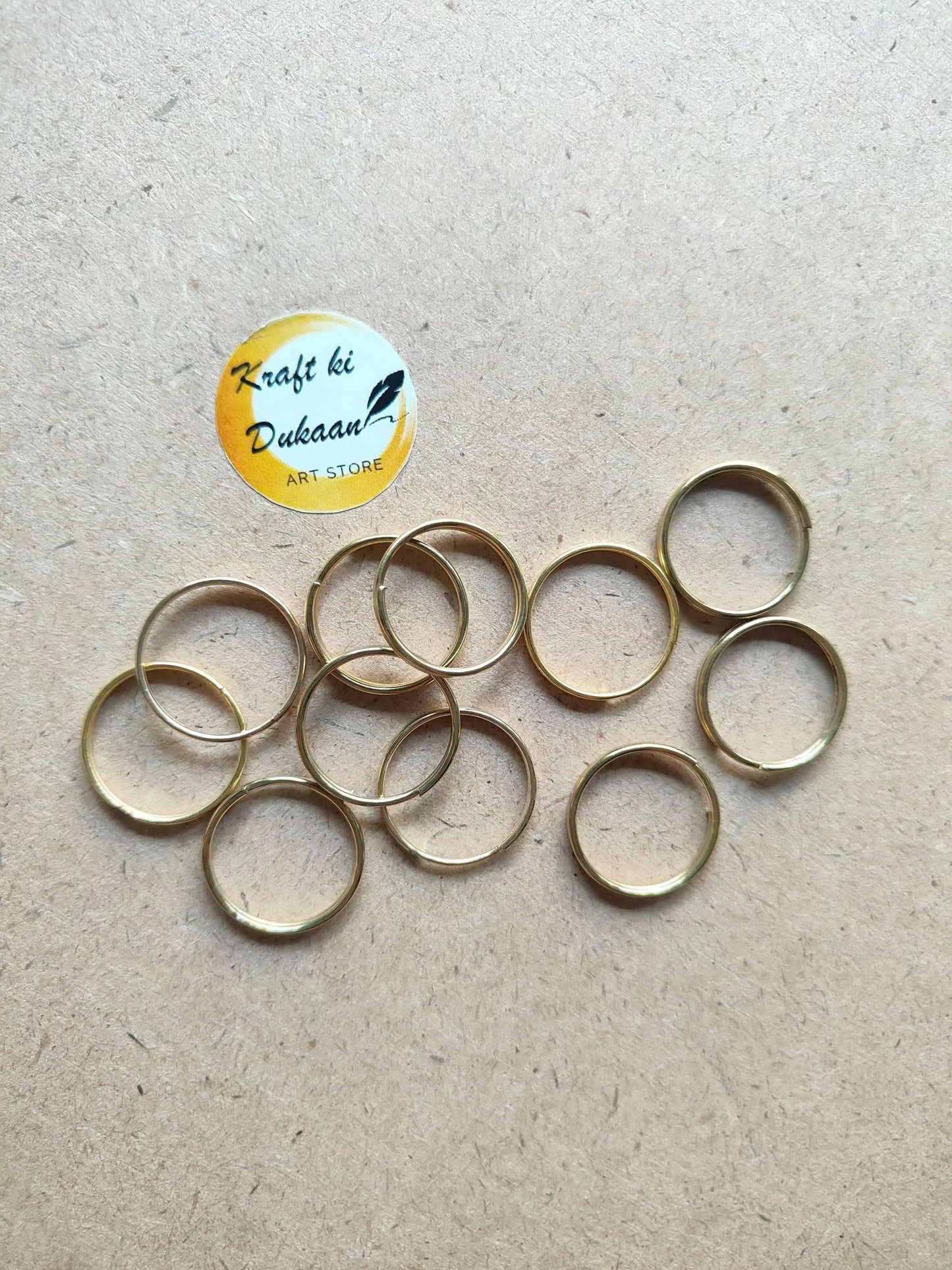 Golden metal round rings, thin hoops with open centers, overlapping spread