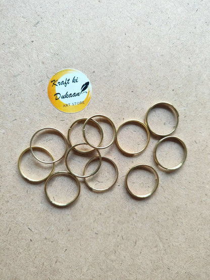 Golden metal round rings, thin hoops with open centers, overlapping spread