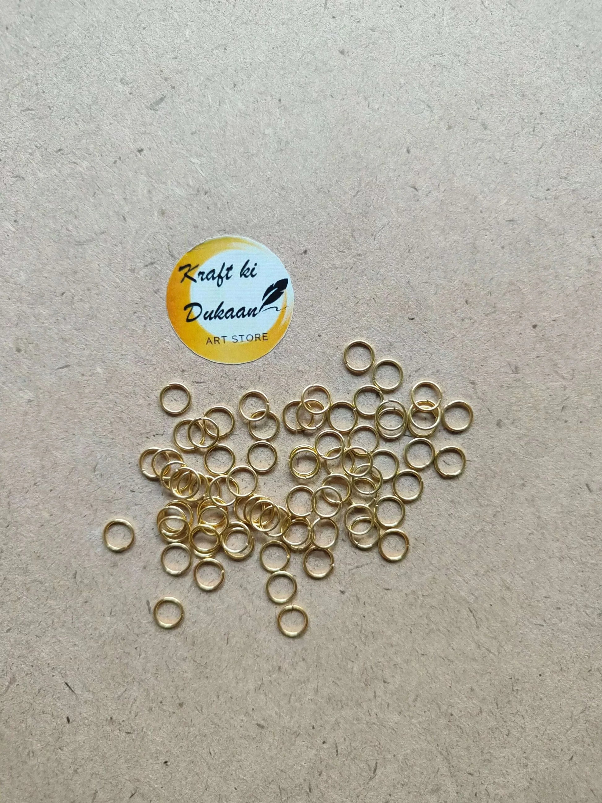 Golden metal round rings, thin hoops with open centers, clustered pile