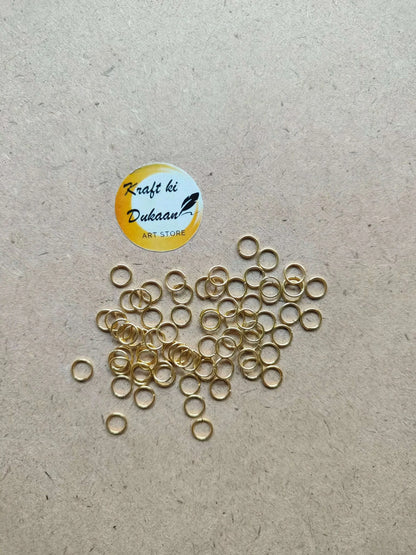Golden metal round rings, thin hoops with open centers, clustered pile