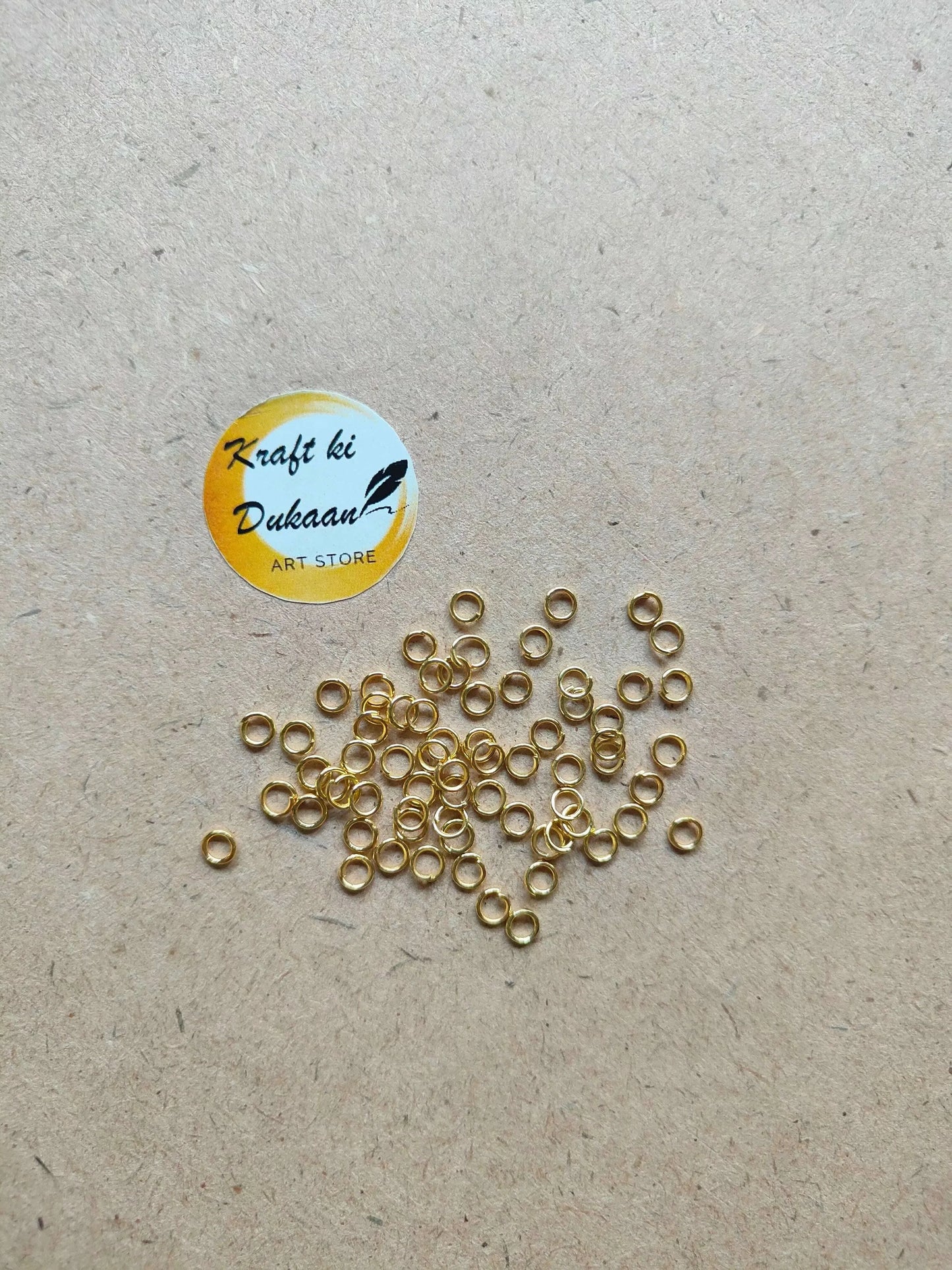 Many small golden metal ring loops with open centers, mixed arrangement