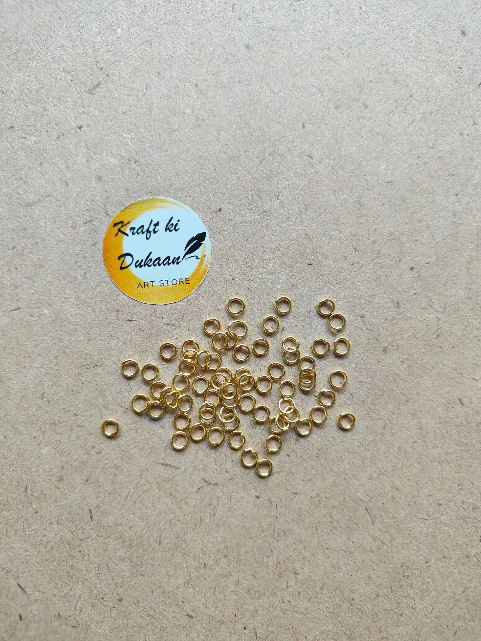 Many small golden metal ring loops with open centers, mixed arrangement