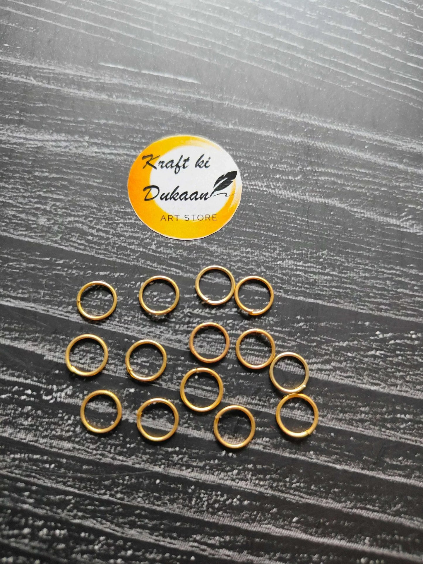 Assorted golden metal jump rings, small round loops with open centers